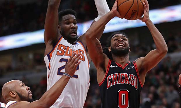 Coby White #0 of the Chicago Bulls puts up a shot against Deandre Ayton #22 of the Phoenix Suns at ...