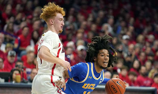 UCLA guard Tyger Campbell (10) drives on Arizona guard Nico Mannion during the first half of an NCA...