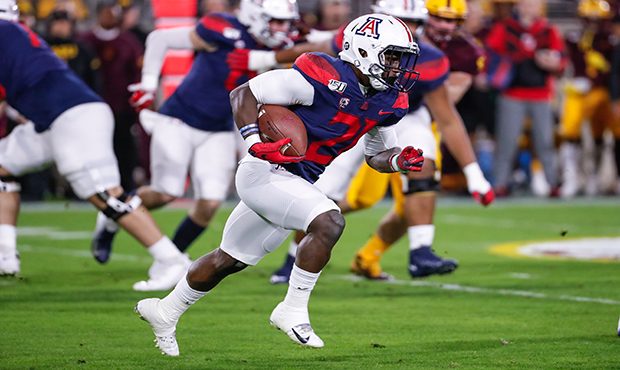 Arizona Wildcats running back J.J. Taylor (21) runs the ball during the college football game betwe...