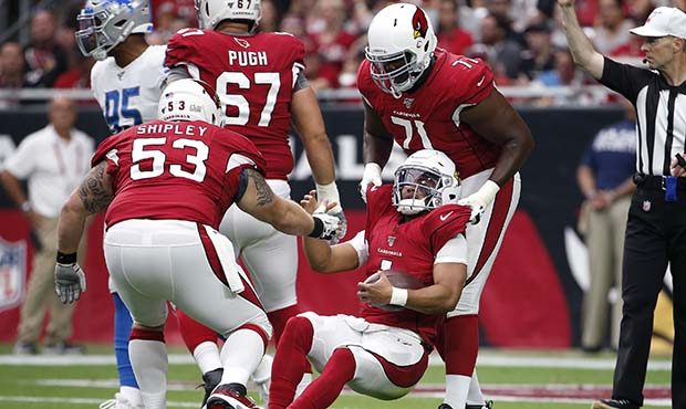 Quarterback Kyler Murray #1 of the Arizona Cardinals (C) is helped up by offensive linemen A.Q. Shi...