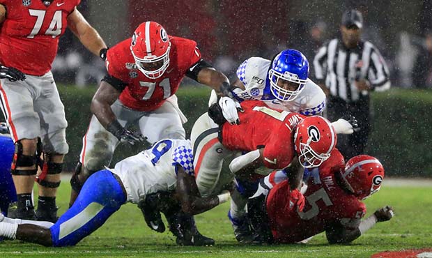 Tackle Andrew Thomas (71) blocks for running back D'Andre Swift (7) of the Georgia Bulldogs against...
