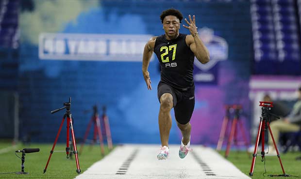Wisconsin running back Jonathan Taylor runs the 40-yard dash at the NFL football scouting combine i...