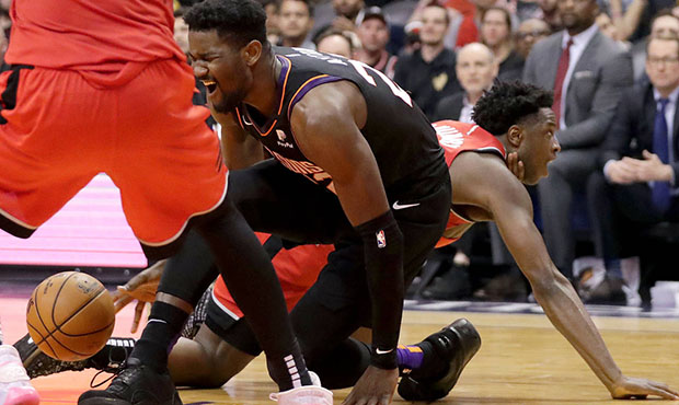 Phoenix Suns center Deandre Ayton falls after getting injured during the second half of an NBA bask...