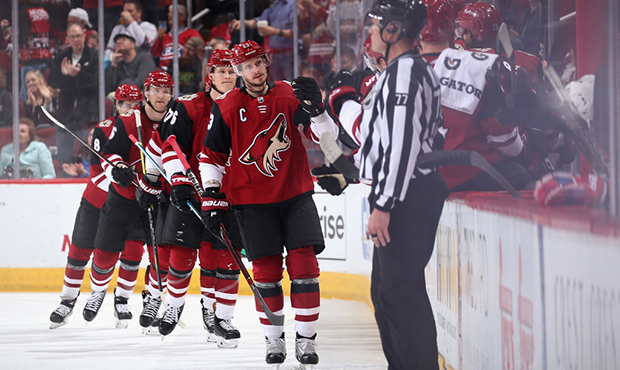 Oliver Ekman-Larsson #23 of the Arizona Coyotes celebrates with teammates on the bench after scorin...