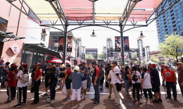 Fans line up outside of Chase Field before the MLB game between the Boston Red Sox and the Arizona ...