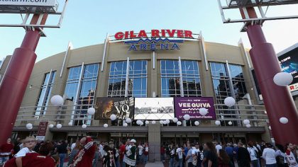 Fans line up outside of Gila River Arena before the NHL game between the Arizona Coyotes and the Wi...