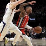 
              Portland Trail Blazers guard Damian Lillard, right, drives to the basket on Phoenix Suns center Aron Baynes, left, during the first quarter of an NBA basketball game in Portland, Ore., Tuesday, March 10, 2020. (AP Photo/Steve Dykes)
            