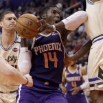Phoenix Suns forward Cheick Diallo (14) drives as Milwaukee Bucks center Brook Lopez, left, looks on during the first half of an NBA basketball game Sunday, March 8, 2020, in Phoenix. (AP Photo/Matt York)