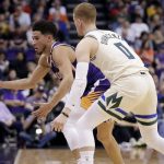 Phoenix Suns guard Devin Booker loses the ball out of bounds as Milwaukee Bucks guard Donte DiVincenzo (0) looks on during the first half of an NBA basketball game Sunday, March 8, 2020, in Phoenix. (AP Photo/Matt York)