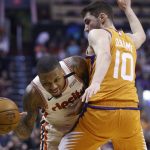 Portland Trail Blazers guard Damian Lillard, left, is fouled as he tries to dribble past Phoenix Suns guard Ty Jerome (10) during the first half of an NBA basketball game Friday, March 6, 2020, in Phoenix. (AP Photo/Ross D. Franklin)