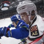 Vancouver Canucks' Bo Horvat, left, checks Arizona Coyotes' Clayton Keller during the first period of an NHL hockey game Wednesday, March 4, 2020, in Vancouver, British Columbia. (Darryl Dyck/The Canadian Press via AP)
