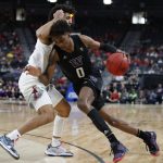 Washington's Jaden McDaniels, right, drives into Arizona's Josh Green during the first half of an NCAA college basketball game in the first round of the Pac-12 men's tournament Wednesday, March 11, 2020, in Las Vegas. (AP Photo/John Locher)