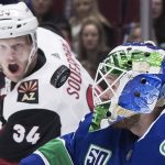 Vancouver Canucks goalie Thatcher Demko, right, makes a save as Arizona Coyotes' Carl Soderberg, of Sweden, watches during the first period of an NHL hockey game Wednesday, March 4, 2020, in Vancouver, British Columbia. (Darryl Dyck/The Canadian Press via AP)