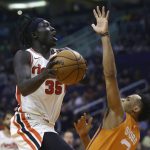 Portland Trail Blazers forward Wenyen Gabriel (35) is fouled by Phoenix Suns forward Elie Okobo, right, during the first half of an NBA basketball game Friday, March 6, 2020, in Phoenix. (AP Photo/Ross D. Franklin)