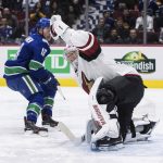 Arizona Coyotes goalie Darcy Kuemper, front right, makes a glove save to stop Vancouver Canucks' Jake Virtanen on a breakaway during the second period of an NHL hockey game Wednesday, March 4, 2020, in Vancouver, British Columbia. (Darryl Dyck/The Canadian Press via AP)