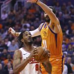 Portland Trail Blazers forward Trevor Ariza (8) drives past Phoenix Suns guard Ricky Rubio (11) during the first half of an NBA basketball game Friday, March 6, 2020, in Phoenix. (AP Photo/Ross D. Franklin)