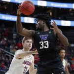 Washington's Isaiah Stewart (33) grabs a rebound over Arizona's Stone Gettings (13) during the first half of an NCAA college basketball game in the first round of the Pac-12 men's tournament Wednesday, March 11, 2020, in Las Vegas. (AP Photo/John Locher)