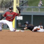 San Francisco Giants' Mauricio Dubon is tagged out by Arizona Diamondbacks' Nick Ahmed during the second inning of a spring training baseball game, Monday, March 2, 2020, in Scottsdale, Ariz.(AP Photo/Darron Cummings)