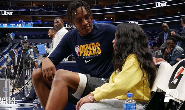 Indiana Pacers center Myles Turner speaks with sixth-grader A’Myah Moon before a game against the...