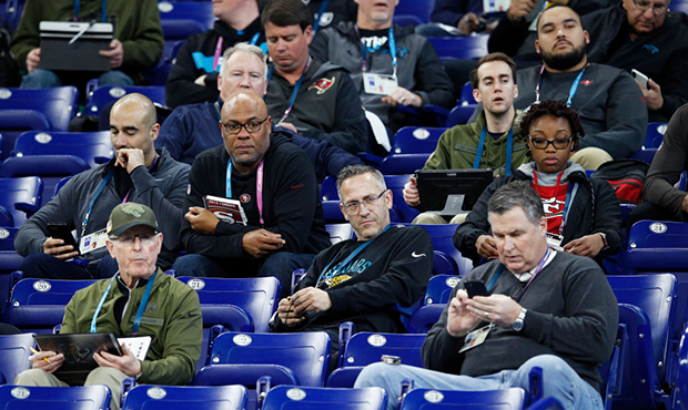 A group of coaches and scouts from various NFL teams observe the action during day two of the NFL C...