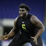 FILE - In this Feb. 28, 2020, file photo, Louisville offensive lineman Mekhi Becton runs a drill at the NFL football scouting combine in Indianapolis. Becton is a possible pick at the NFL Draft which runs Thursday, April 23, 2020 thru Saturday, April 25. (AP Photo/Michael Conroy, File)
