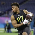 FILE - In this Feb. 28, 2020, file photo, Wisconsin running back Jonathan Taylor runs a drill at the NFL football scouting combine in Indianapolis. (AP Photo/Michael Conroy, File)