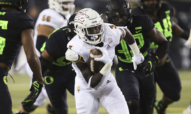 Arizona State's Eno Benjamin runs against Oregon defenders during the first quarter of an NCAA coll...