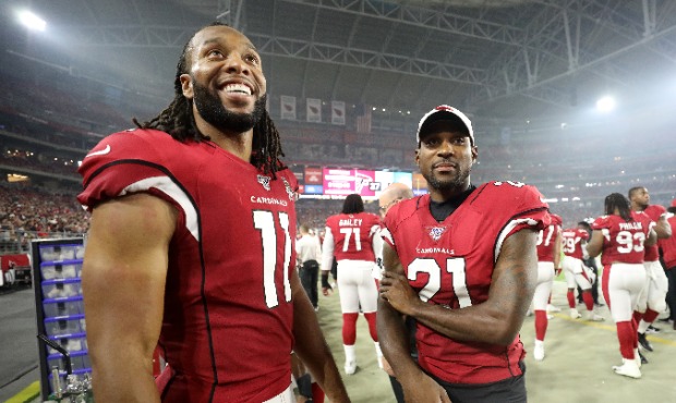 Larry Fitzgerald #11 and Patrick Peterson #21 of the Arizona Cardinals stand on the sideline during...