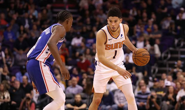 Devin Booker #1 of the Phoenix Suns handles the ball during the second half of the NBA game against...