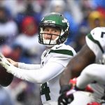 FILE - In this Dec. 29, 2019, file photo, New York Jets quarterback Sam Darnold (14) throws a pass during the first half of an NFL football game against the Buffalo Bills in Orchard Park, N.Y. Darnold was mostly pleased with how he finished last year with the New York Jets. The young quarterback enters his third NFL season knowing he needs to be even better. (AP Photo/Adrian Kraus, File)