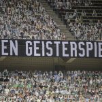 A banner reading "Against ghost matches" is displayed during the German Bundesliga soccer match between Borussia Moenchengladbach and Leverkusen, in Moenchengladbach, Germany, Saturday, May 23, 2020. (Ina Fassbender Pool Photo via AP)