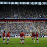 Fortuna Duesseldorf's players warm up prior to the Bundesliga soccer match between Duesseldorf and  Paderborn in the Merkur Spiel-Arena, Duesseldorf, Germany, Saturday, May 16, 2020. The German Bundesliga becomes the world's first major soccer league to resume after a two-month suspension because of the coronavirus pandemic. (Sascha Schuermann/AFP pool via AP)