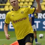 Dortmund's Erling Haaland celebrates after scoring the opening goal during the German Bundesliga soccer match between Borussia Dortmund and Schalke 04 in Dortmund, Germany, Saturday, May 16, 2020. The German Bundesliga becomes the world's first major soccer league to resume after a two-month suspension because of the coronavirus pandemic. (AP Photo/Martin Meissner, Pool)