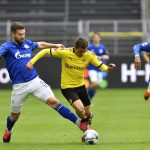 Schalke's Matija Nastasic, left, fouls Dortmund's Thorgan Hazard during the German Bundesliga soccer match between Borussia Dortmund and Schalke 04 in Dortmund, Germany, Saturday, May 16, 2020. The German Bundesliga becomes the world's first major soccer league to resume after a two-month suspension because of the coronavirus pandemic. (AP Photo/Martin Meissner, Pool)