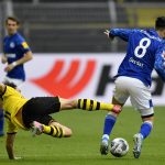 Dortmund's Thomas Delaney fights for the ball with Schalke's Suat Serdar, right, during the German Bundesliga soccer match between Borussia Dortmund and Schalke 04 in Dortmund, Germany, Saturday, May 16, 2020. The German Bundesliga becomes the world's first major soccer league to resume after a two-month suspension because of the coronavirus pandemic. (AP Photo/Martin Meissner, Pool)