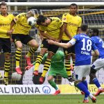 Schalke's Daniel Caligiuri, foreground, has his free kick blocked during the German Bundesliga soccer match between Borussia Dortmund and Schalke 04 in Dortmund, Germany, Saturday, May 16, 2020. The German Bundesliga becomes the world's first major soccer league to resume after a two-month suspension because of the coronavirus pandemic. (AP Photo/Martin Meissner, Pool)