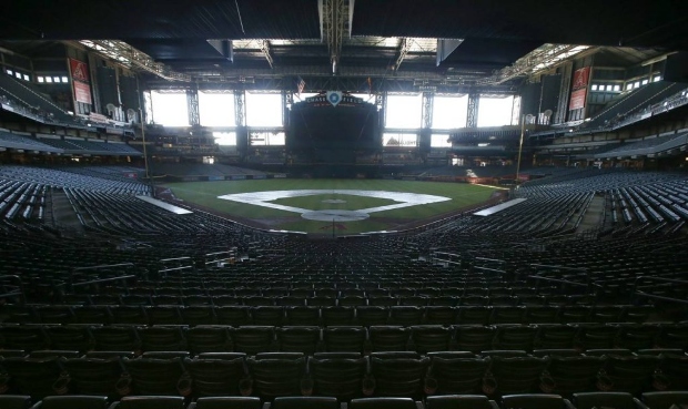 FILE - In this Tuesday, April 28, 2020, file photo, a darkened Chase Field, home of the Arizona Dia...