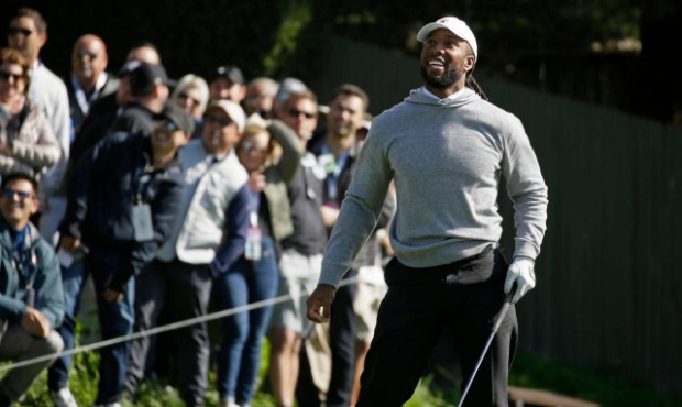 Larry Fitzgerald follows his drive from the 15th tee of the Pebble Beach Golf Links during the thir...
