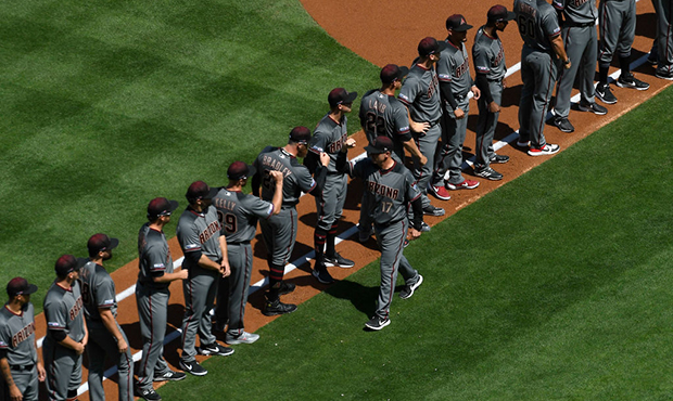 Manager Torey Lovullo #17 of the Arizona Diamondbacks is greeted by his players as they line up for...