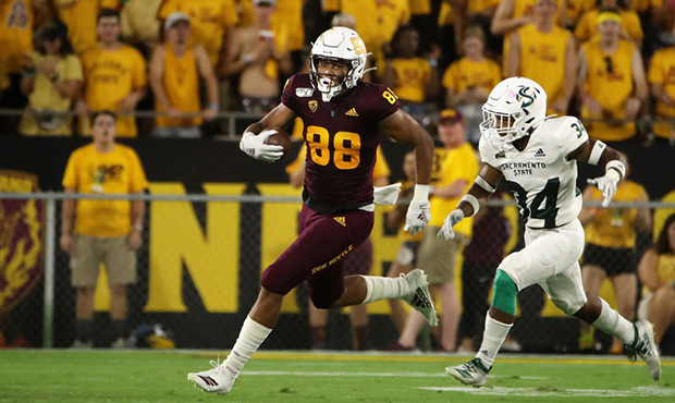 Tight end Nolan Matthews #88 of the Arizona State Sun Devils runs with the football ahead of defens...