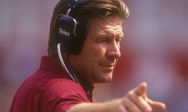 Head coach Joe Bugel of the Phoenix Cardinals signals to his players during a football game against...