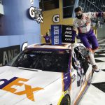 Denny Hamlin jumps from his car after winning a NASCAR Cup Series auto race Sunday, June 14, 2020, in Homestead, Fla. (AP Photo/Wilfredo Lee)