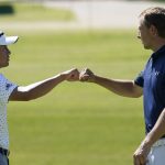 Coilin Morikawa, left, pumps fists with Jordan Spieth on the 18th green after their final round of the Charles Schwab Challenge golf tournament at the Colonial Country Club in Fort Worth, Texas, Sunday, June 14, 2020. (AP Photo/David J. Phillip)