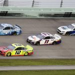 Cars come through a turn during a NASCAR Cup Series auto race Sunday, June 14, 2020, in Homestead, Fla. (AP Photo/Wilfredo Lee)