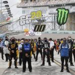 Drivers and crew members stand during a prayer before a NASCAR Cup Series auto race Sunday, June 14, 2020, in Homestead, Fla. (AP Photo/Wilfredo Lee)