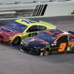 Ryan Blaney (12) and Chase Elliott (9) battle for the lead during a NASCAR Cup Series auto race Sunday, June 14, 2020, in Homestead, Fla. (AP Photo/Wilfredo Lee)