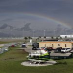 A rainbow stretches behind Homestead-Miami Speedway during a weather delay at a NASCAR Cup Series auto race Sunday, June 14, 2020, in Homestead, Fla. (AP Photo/Wilfredo Lee)