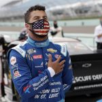 Bubba Wallace stands for the national anthem before a NASCAR Cup Series auto race Sunday, June 14, 2020, in Homestead, Fla. (AP Photo/Wilfredo Lee)