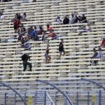 Fans watch during a NASCAR Cup Series auto race Sunday, June 14, 2020, in Homestead, Fla. (AP Photo/Wilfredo Lee)