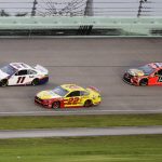 Denny Hamlin (11) leads Joey Logano (22) and Martin Truex Jr. (19) during a NASCAR Cup Series auto race Sunday, June 14, 2020, in Homestead, Fla. (AP Photo/Wilfredo Lee)